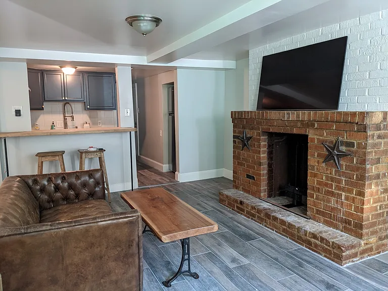 Living room from front window, facing kitchen and hallway to bedroom.