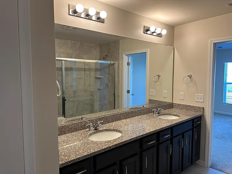 A view from within the toilet room looking out toward the bathroom.