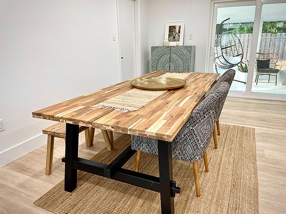 Huge real wood dining table fits up to 8 people comfortably. Perfect for family meals.