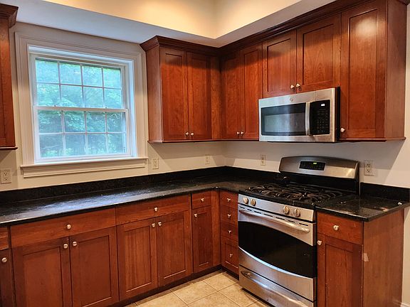Kitchen with cherry cabinets with lights underneath.