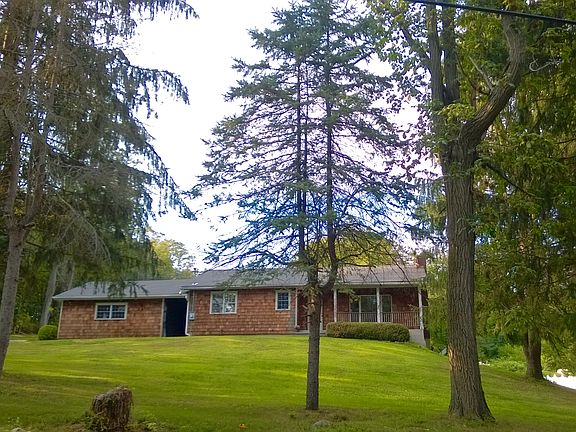 Front view of house. Set back on quiet, country road.