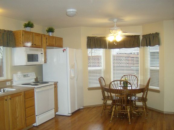 Kitchen features hardwood floors sunny eating area