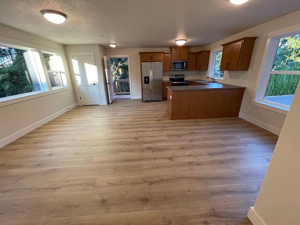 Full view of living room, kitchen, and dining area