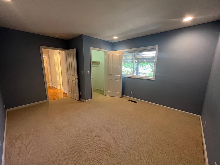Bedroom #1 has a walk-in closet and comfortable plush carpeting.