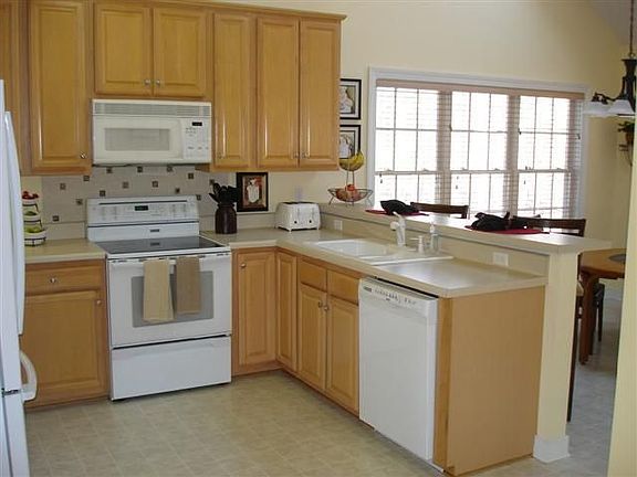 Kitchen - tile backspash over oven, crown molding, lazy susan corner cabinets