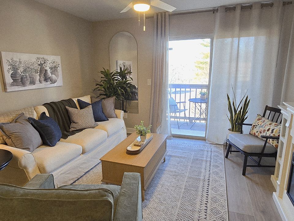 Inviting living room centered around a cozy fireplace with seamless access to the deck.
