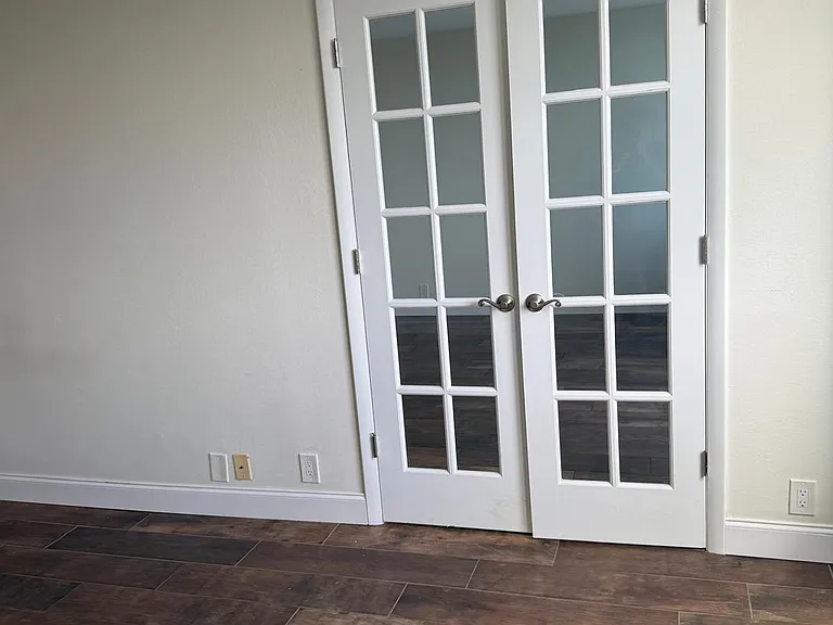 French doors between living room and bedroom