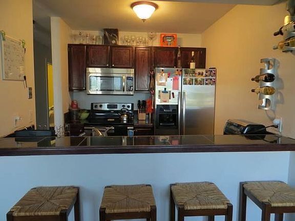 Kitchen with stainless steel appliances and bar