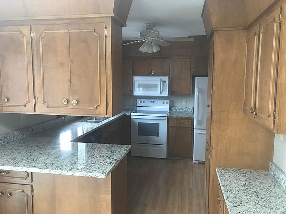 New granite counters, maple cabinets, built-in writing desk on right.
