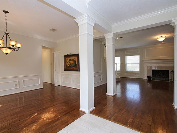 To the left of the entry is the formal dining room featuring hardwood flooring and wonderful chair rail and picture frame molding. The columns make this entertaining space so spacious and elegant!