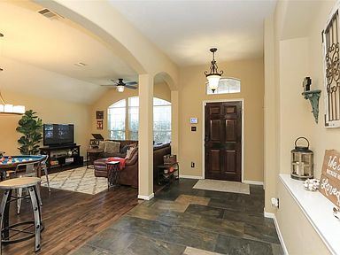 The hardwood front door opens to a slate-tiled Foyer and open concept formal living and dining space. The current Homeowners use this space as a Gameroom for entertaining friends and family.