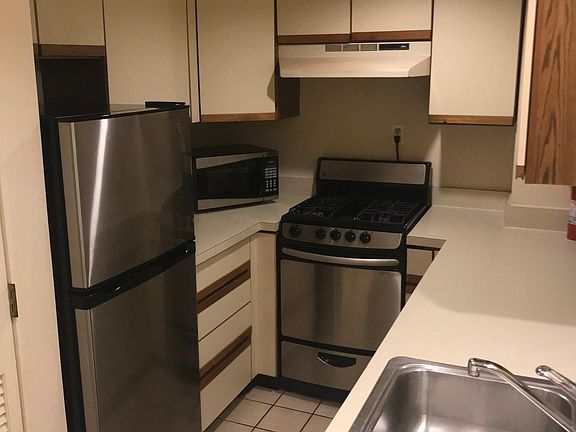 Kitchen with refrigerator, microwave oven, gas range, dishwasher, sink with disposal