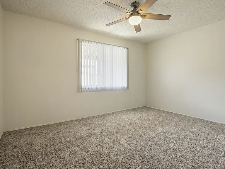 Bedroom with carpeted flooring, and ceiling fan