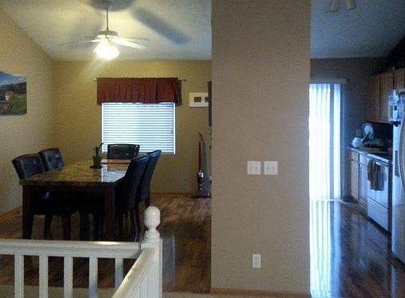 Hardwood floor and vaulted ceiling in kitchen and dining area.