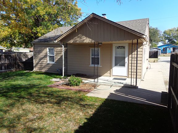 Tree shaded front porch, patio, and sidewalk connecting to the back porch