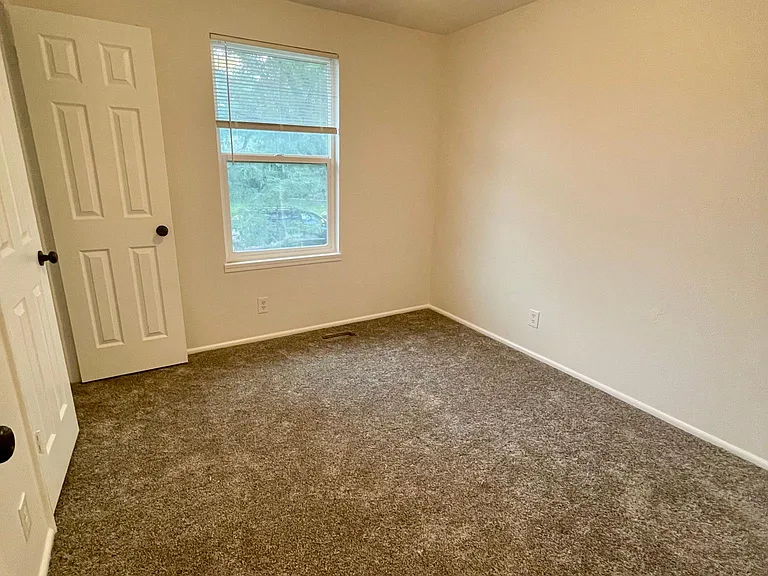 1 of 3 main floor bedrooms. South facing window for winter sunshine.