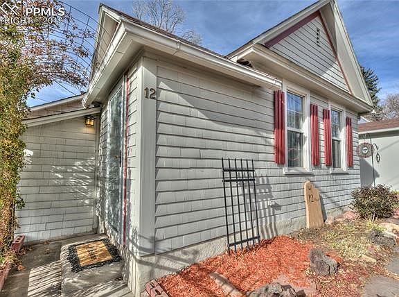 Rose arbor covered front door enters into foyer