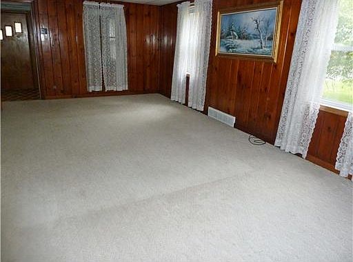 Notice the natural woodwork in the living room.