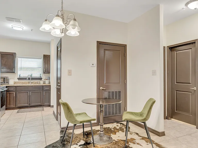 Interior of a kitchen at La Joya Apartments in Laredo, Texas, showcasing a table with chairs