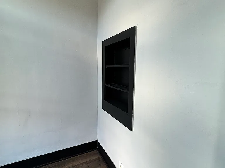 The small room off of the living area has a small set of shelving for books or whatever you desire.