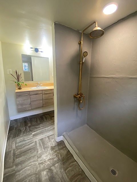 Spacious bathroom is off the kitchen.