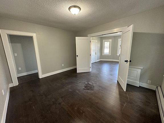 the second image of the living room, the doors open to bedroom 1.