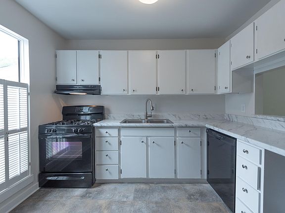 Sunny kitchen with new gas stove, dishwasher, refrigerator and pantry
