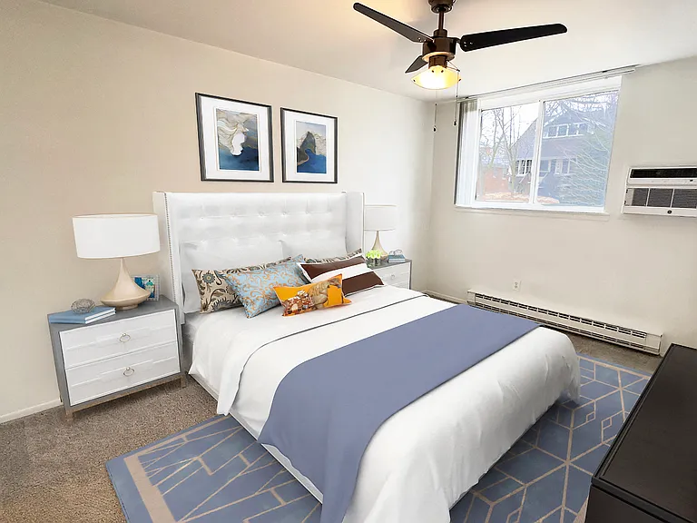 Primary bedroom has large walk-in closet, ceiling fan, air conditioningm, plush carpeting.