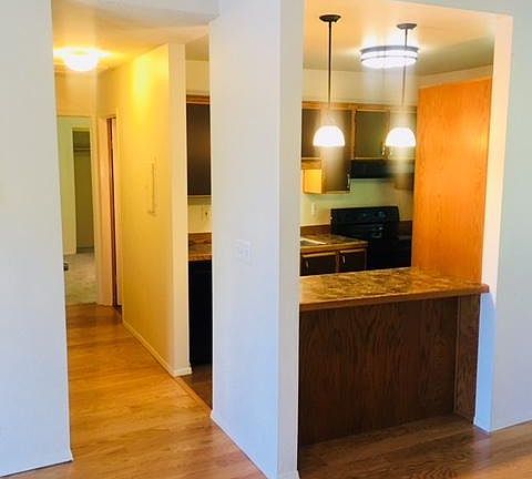 Kitchen and hallway leading to bathroom and bedrooms.