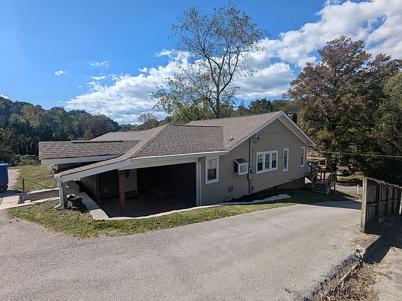 View of back, northern corner of the house, from parking area.