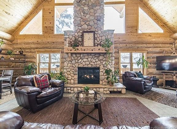 Cozy up by the stunning floor to ceiling stone gas fireplace