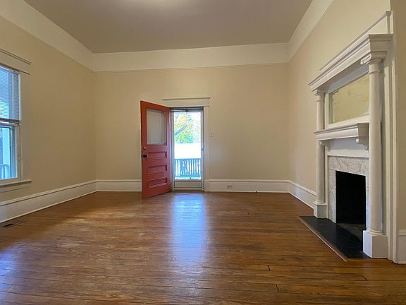 The handsome fireplaces in the living room and kitchen are decorative.