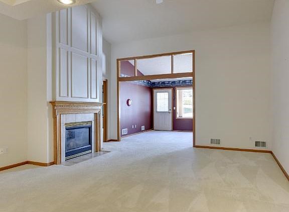The great room flows from the formal dining room into the sun room.