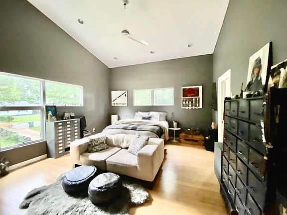 The spacious primary bedroom (photo taken from a few steps inside the bedroom door). The door on the right is the en-suite bathroom with soaker tub, walk-in glass shower, his & hers sinks. On the back wall, not pictured, are the double closets.