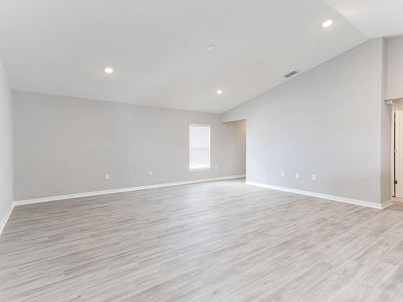 Enjoy an open living area with airy volume ceilings and luxe, low-maintenance vinyl plank flooring -
