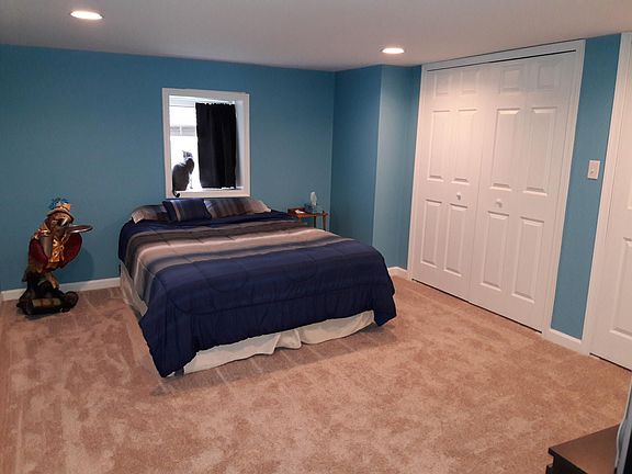 Spacious bedroom with recessed ceiling lights and two closet