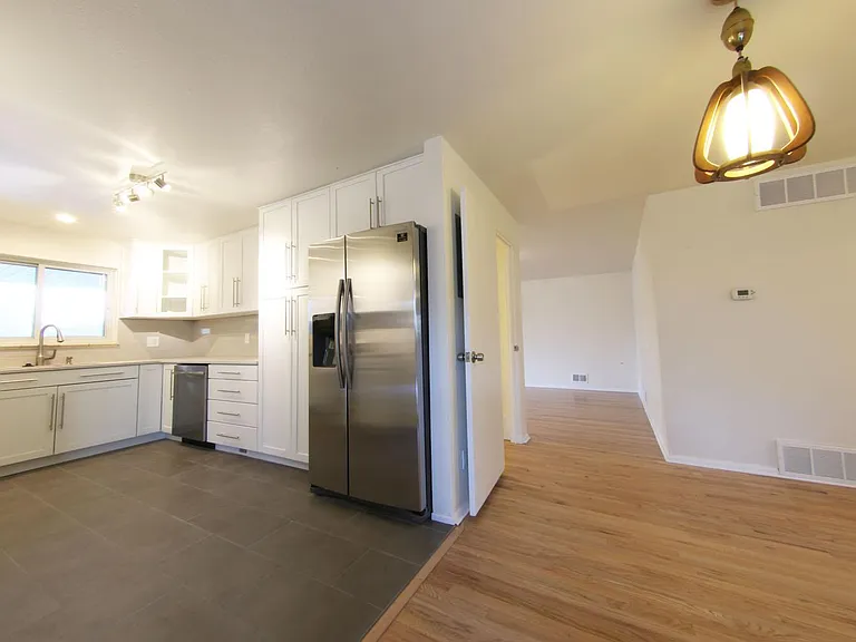 View of the Kitchen from Patio Door looking towards upstairs living area.