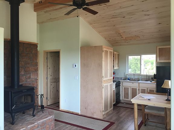 Wood stove, stacked laundry, custom cabinets, full bath 