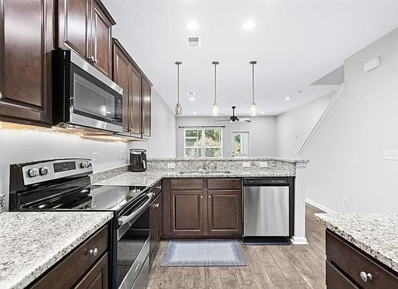 Solid surface countertops and stainless steel appliances