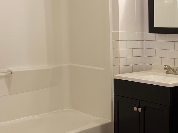Bathroom with vanity, shower and bath tub.