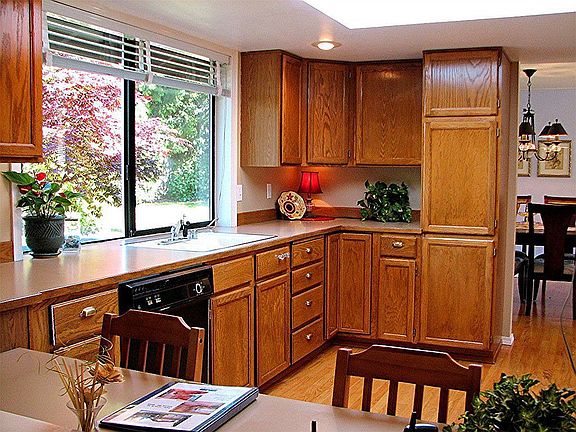 The kitchen also features additional seating as a breakfast bar, or desk.
