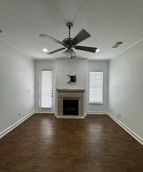 Spacious living area with gas log fireplace and balcony.