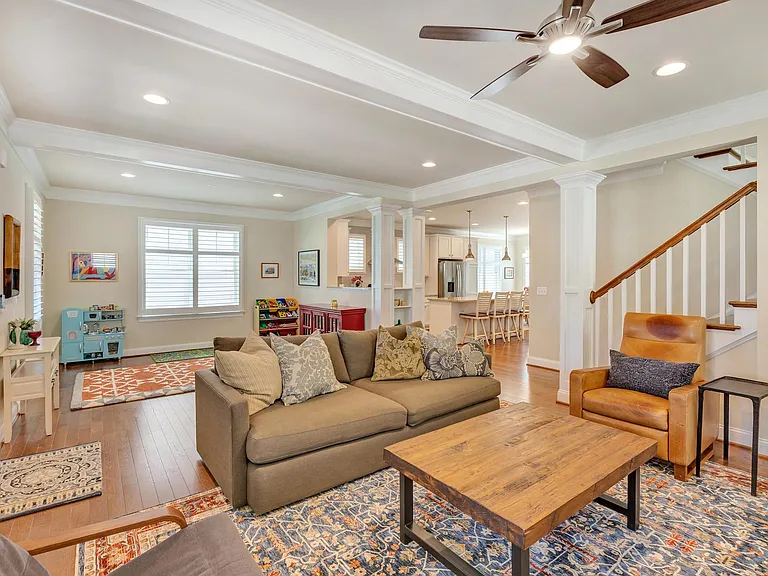 Living room and play area, connecting to the kitchen.
