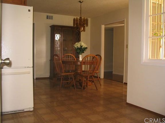 Dining area next to open space and living room