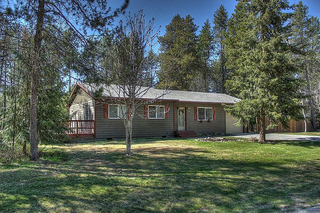 Large corner lot : Mature trees and level gravel driveway.