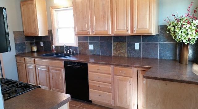 Bright, cheerful, and updated kitchen with beautiful Maple cabinets, newer appliances, lighting, and tile floors all ready for entertaining!