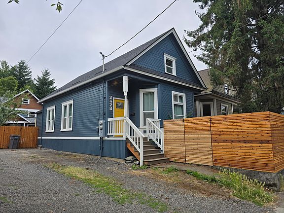 Side view of house including privately fenced front yard.