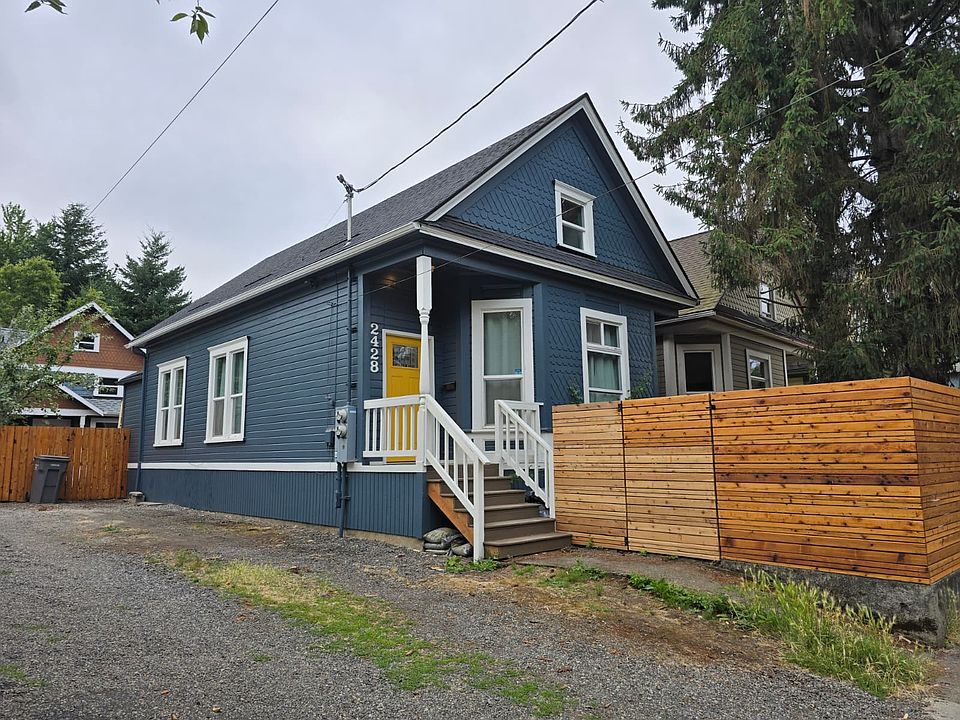 Side view of house including privately fenced front yard.