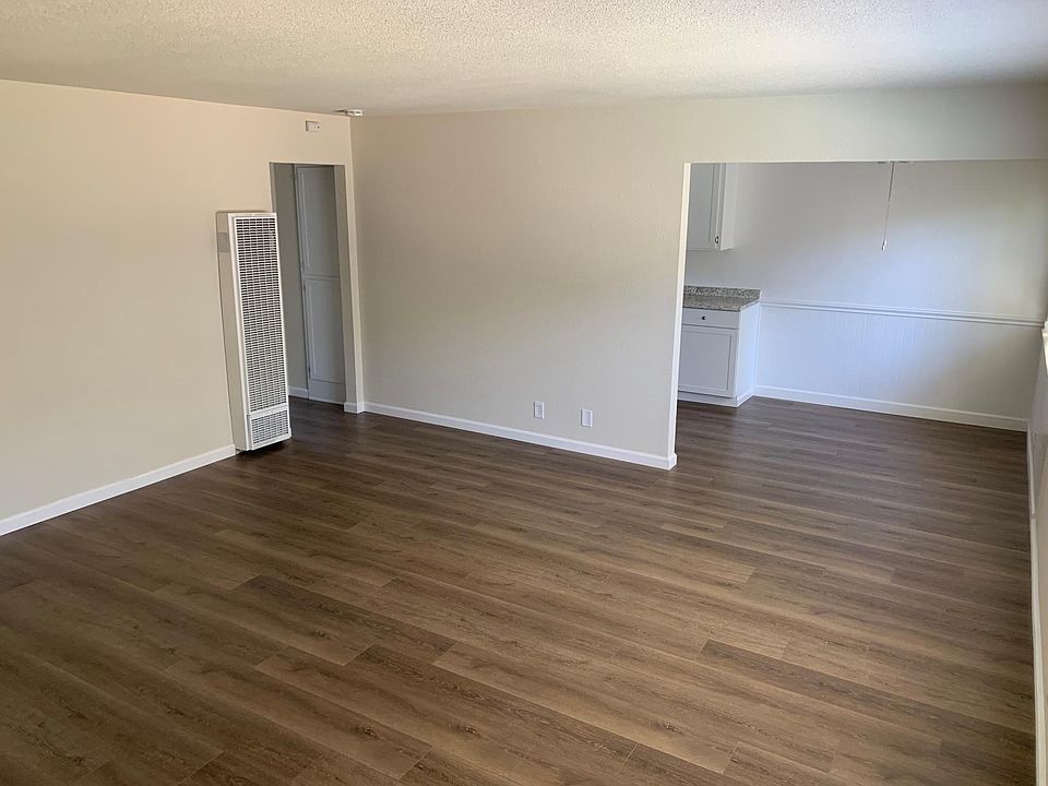 Entering the apartment looking towards the kitchen. New paint, texture, fixtures, and baseboards throughout bring the entire apartment together with a brand new finish.