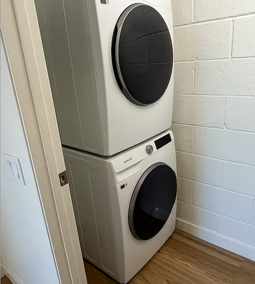 Laundry room with stackable washer and dryer.
